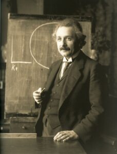 Albert Einstein vor einer Tafel
